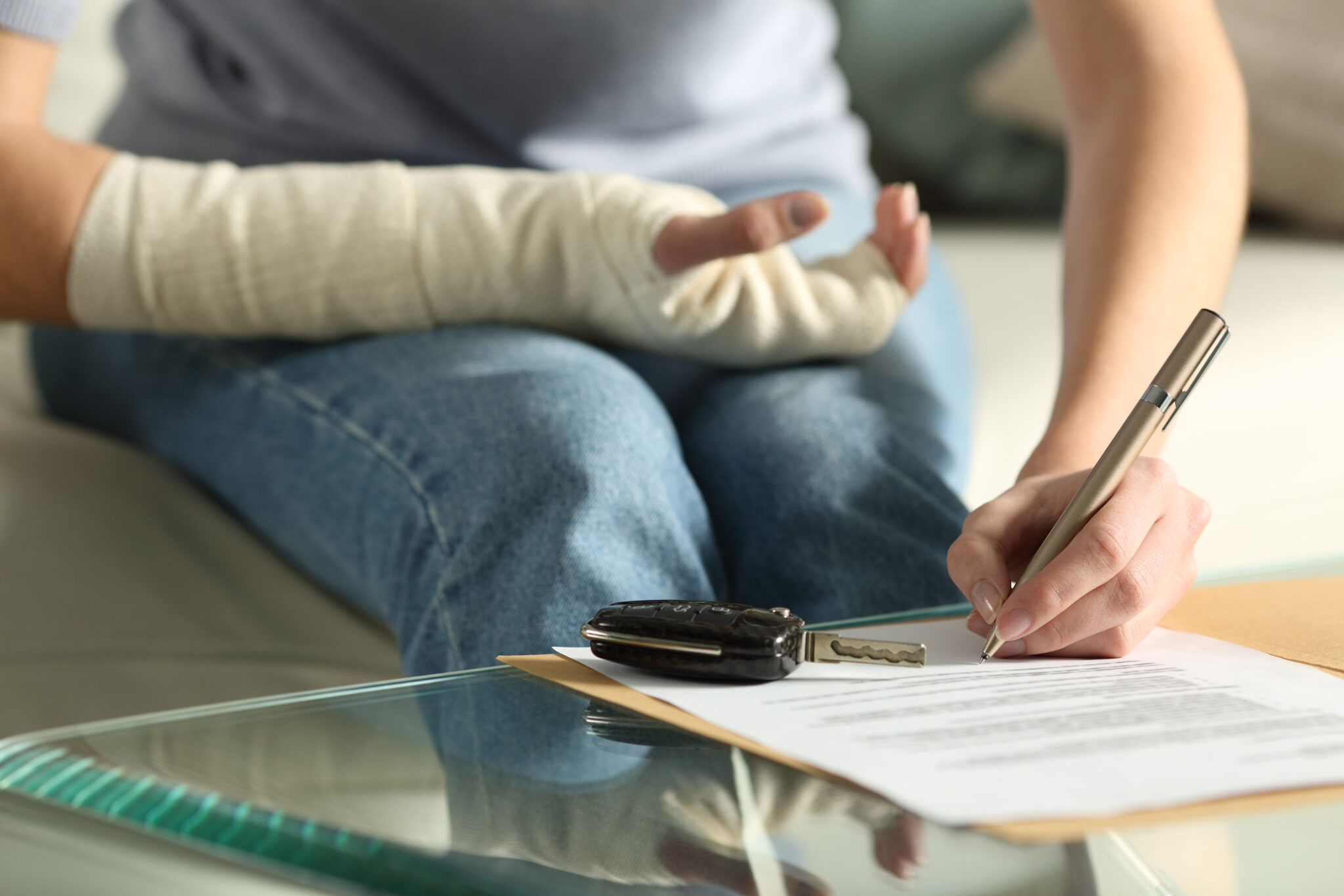 Lady with broken arm signing documents after an accident, with Peter's Law Firm, Council Bluffs